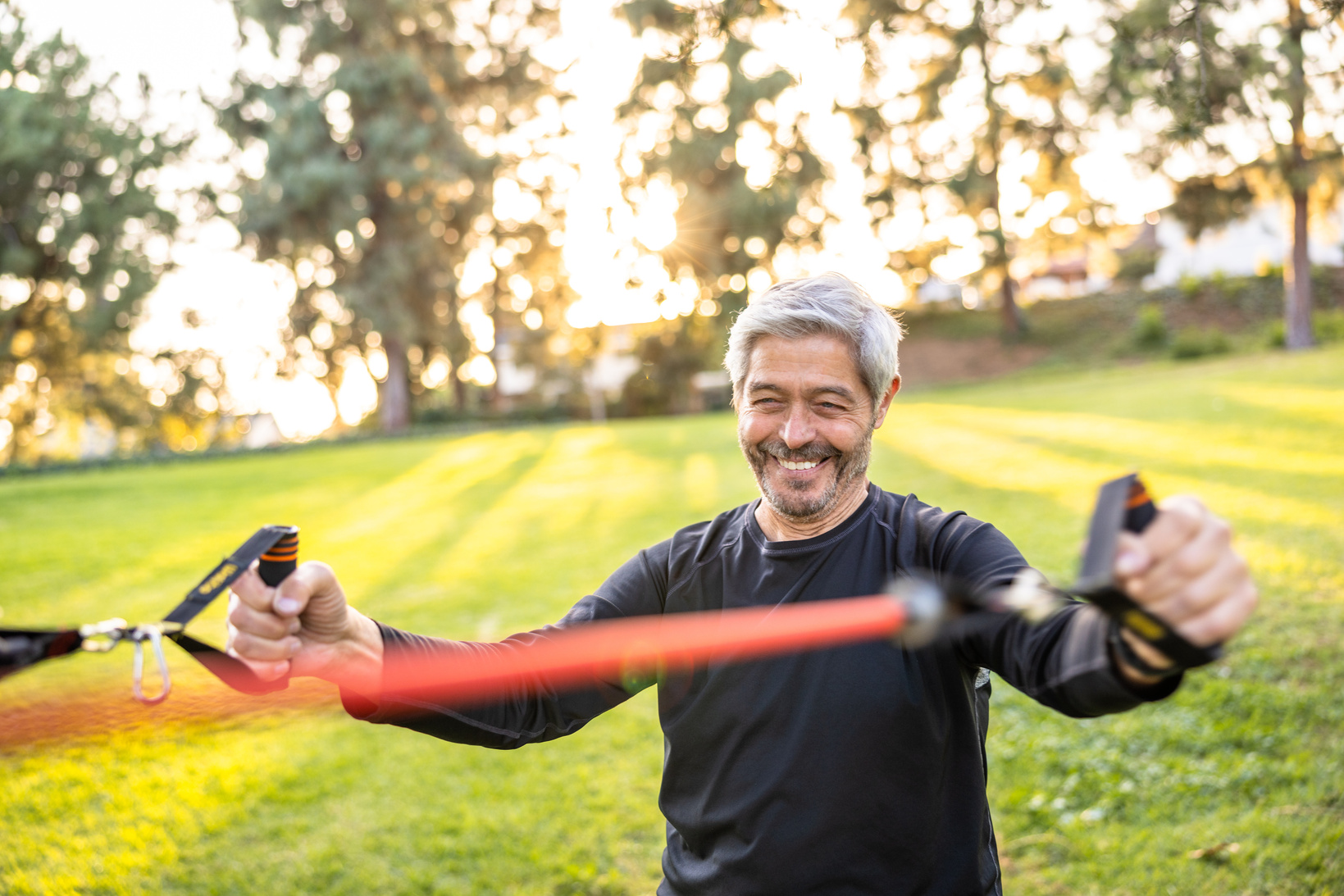 Senior man strength training with resistance bands